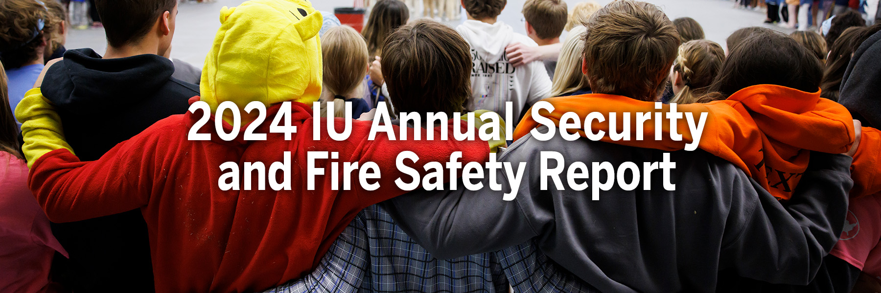 2024 IU Annual Security and Fire Safety Report. In the background are five students with arms crossed over each other's shoulders.