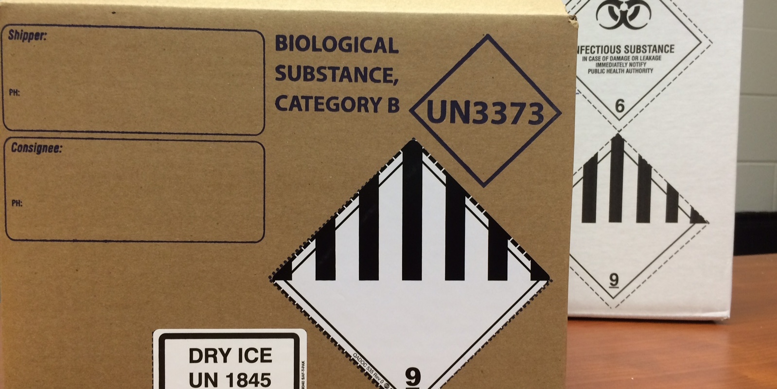 A white box that says "biological substance, category B" and "dry ice" on it.