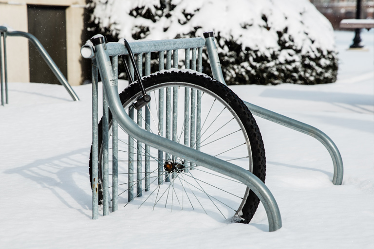 A single bicycle wheel, U-locked to a bike rack. The rest of the bike is stolen; the thief simply unscrewed the bike from the  front wheel and left with it.