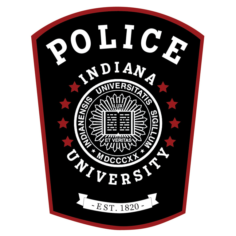A vector image of the IUPD patch, a long narrow navy blue and red emblem with the words POLICE, INDIANA UNIVERSITY, EST. 1820 and a circlet of red stars surrounding the Indiana University Seal.