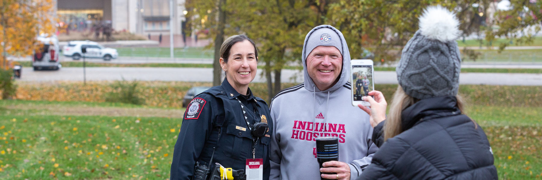 IUPD Police Chief Jill Lees poses with a group of IU football fans while on serving her patrol duties at a game.