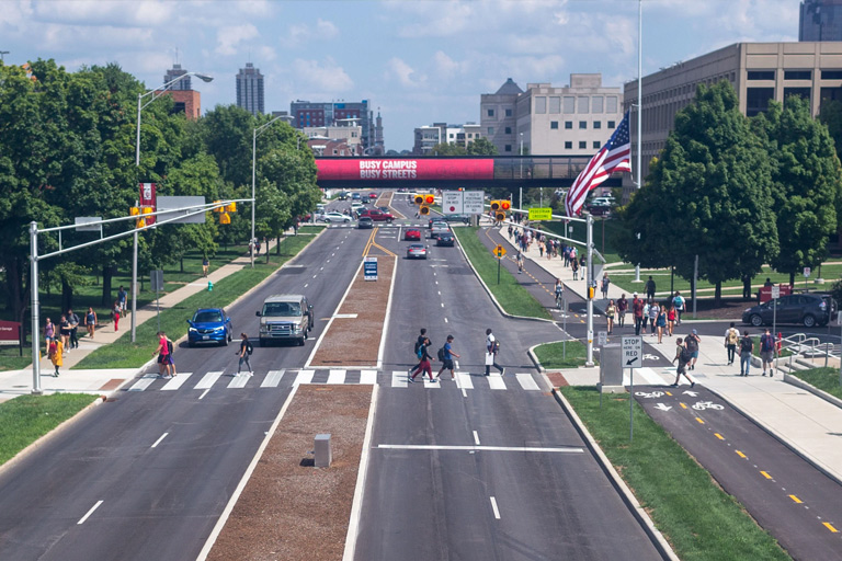 A wide angle aerial view of IUPUI's New York street in Indianapolis, crowded with pedestrian traffic.